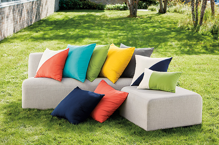 Solid and Maritime outdoor pillows on sofa