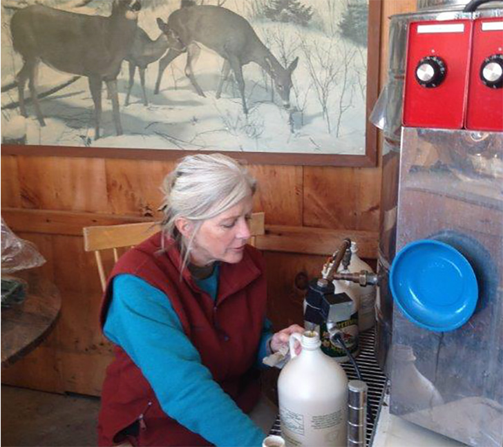 David’s wife Judy canning gallons of maple syrup.