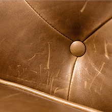 scratches and abrasions in a top-grain, full-aniline-dyed leather