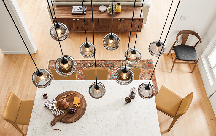 Banded pendant lights above dining table