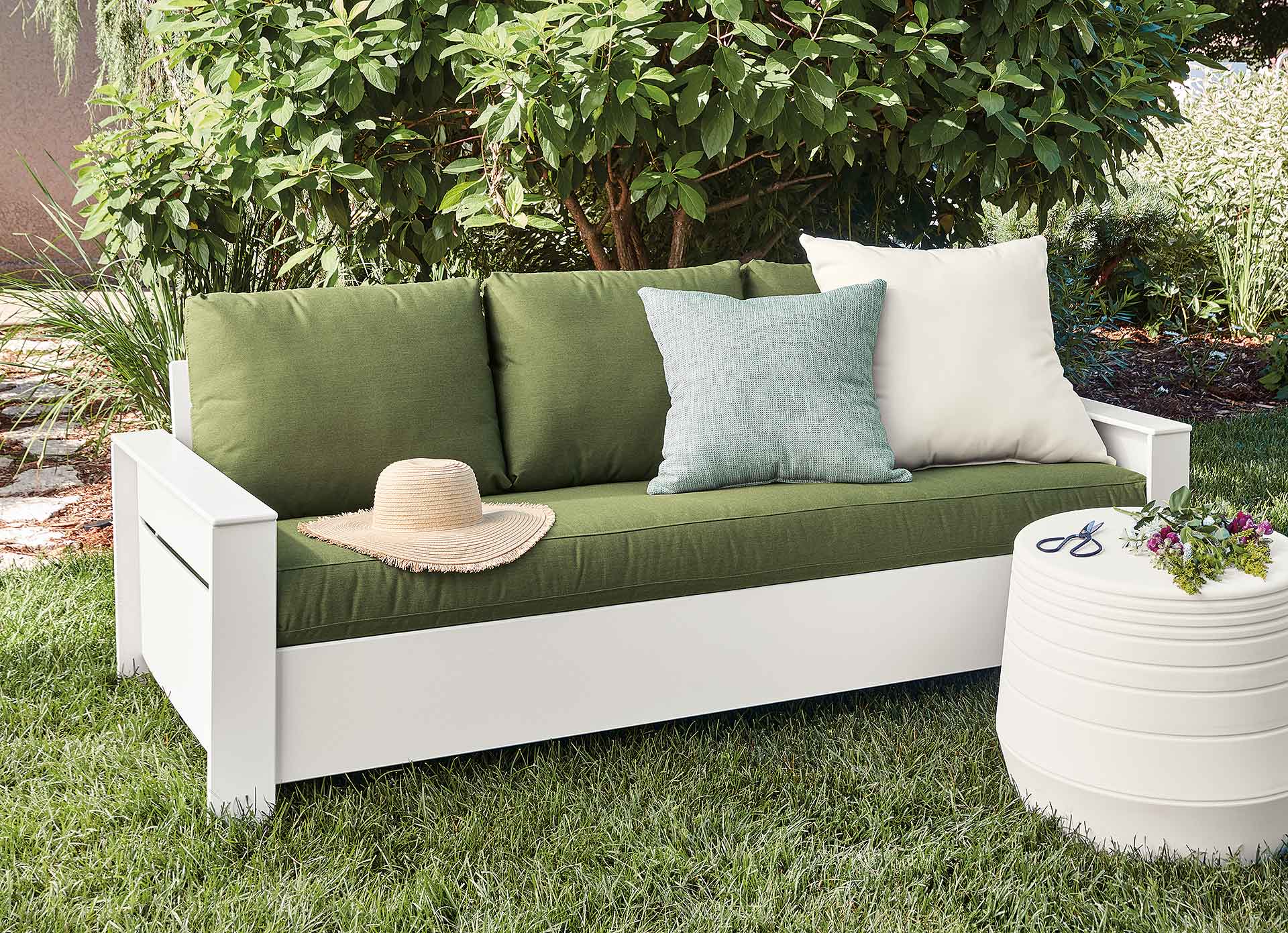 green and white outdoor sofa in lawn