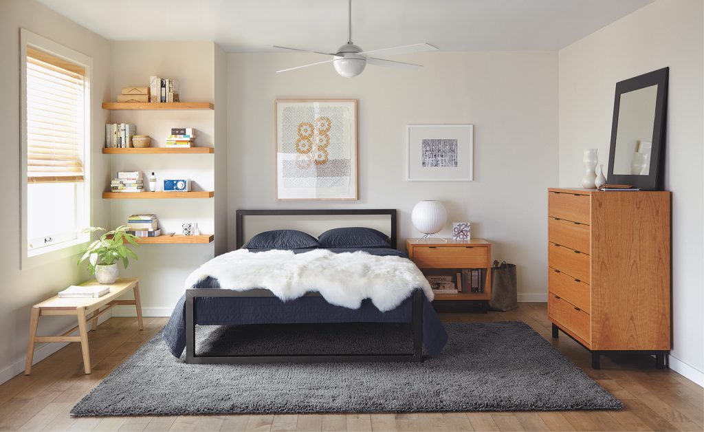 Float wall shelves in bedroom with Parsons bed