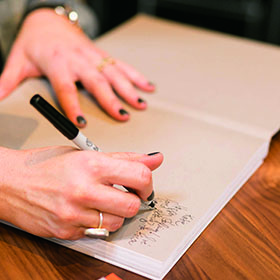 Kirsten signs copies of her book