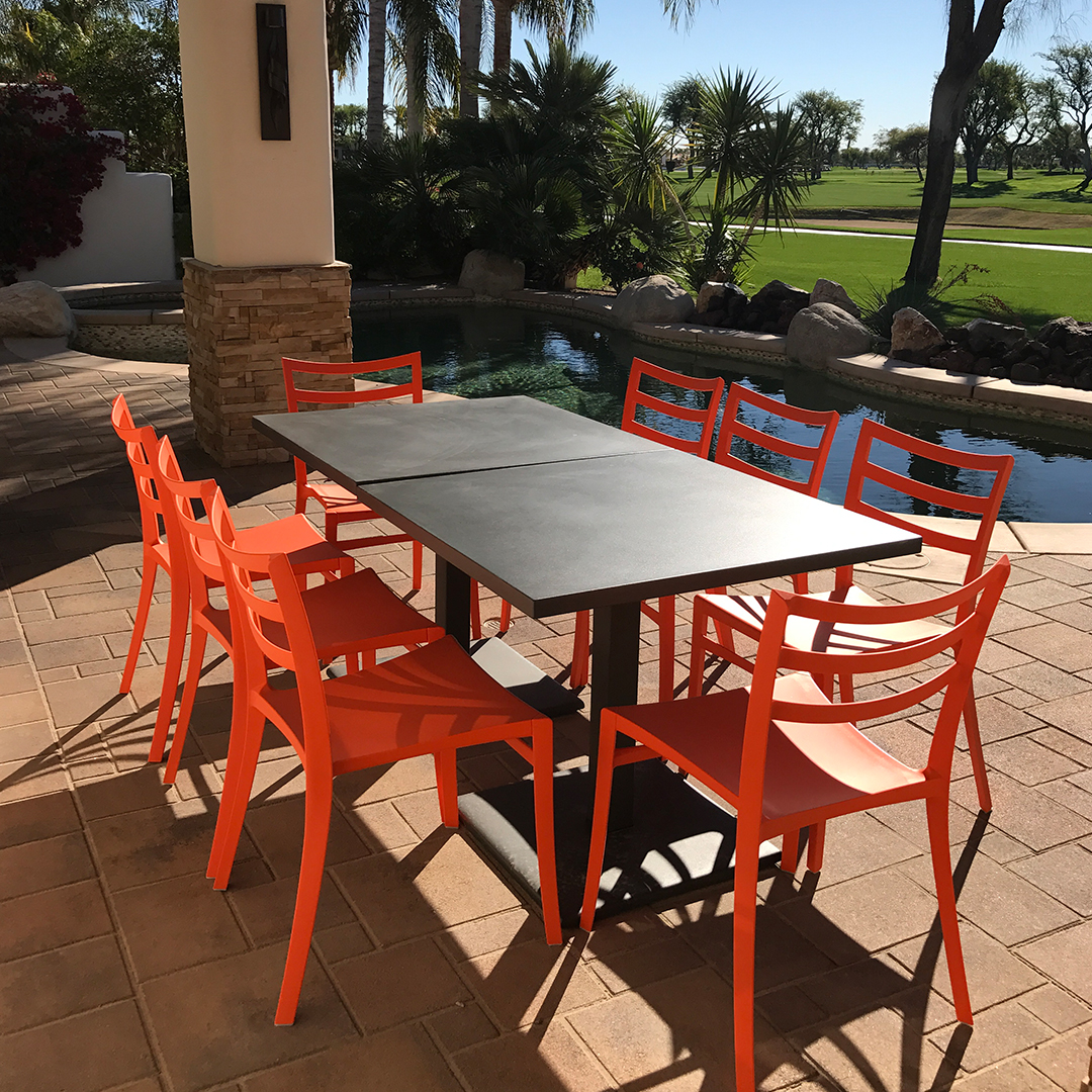 Orange color outdoor Sabrina chairs and Maris tables