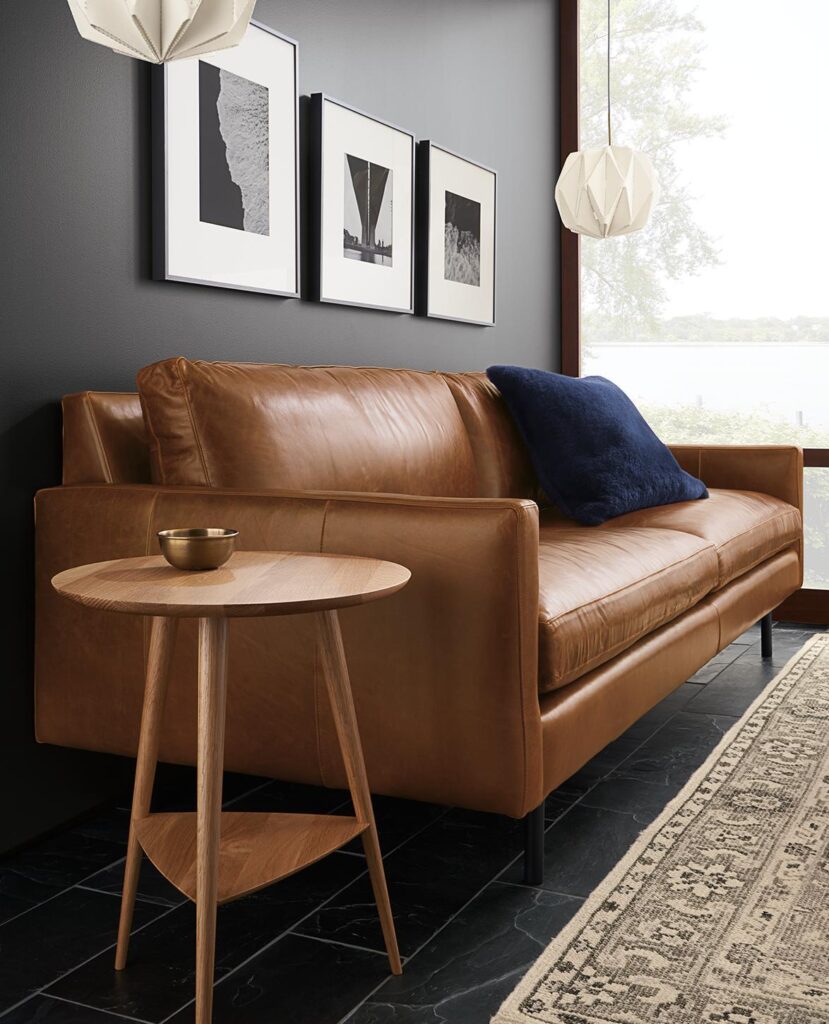 Living room with Rae 18-diameter round end table in White oak with Jasper leather sofa.