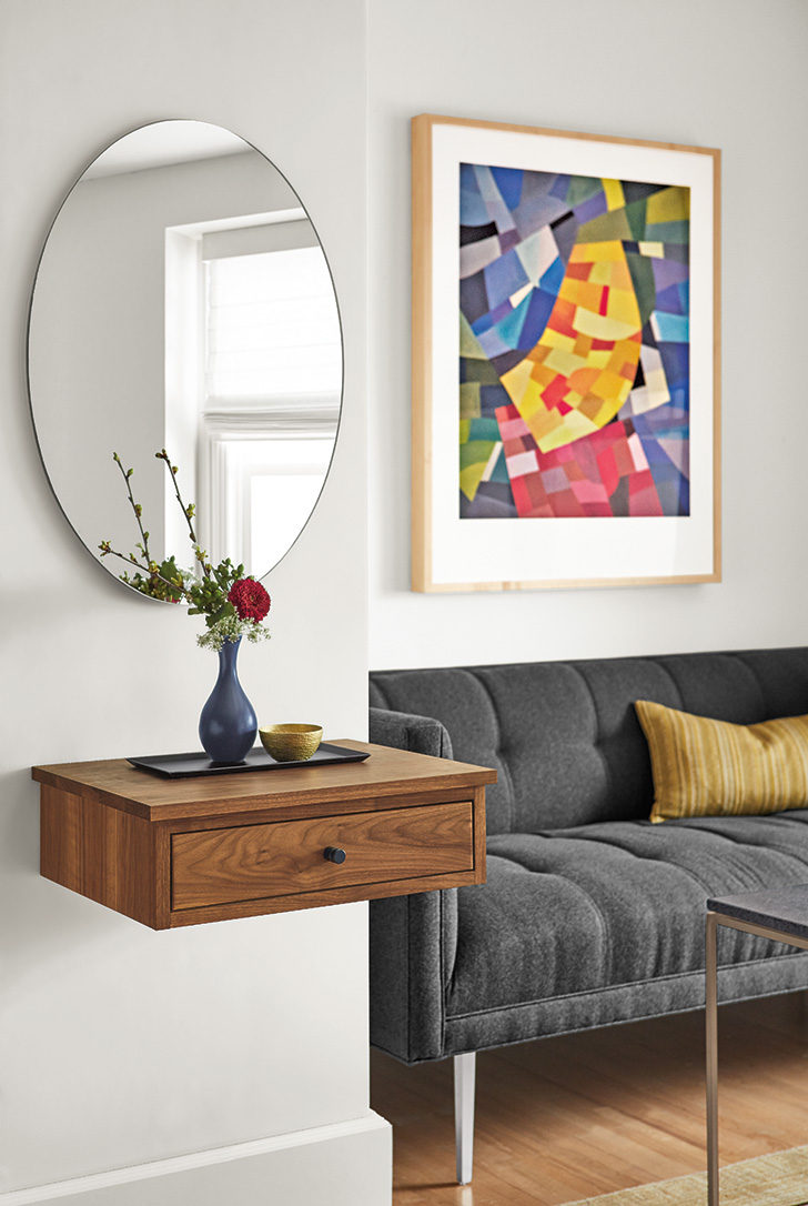 Linear wall-mounted storage in small space entryway