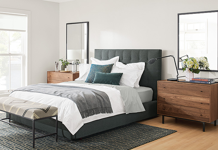 Avery upholstered bed in modern bedroom with layers of grey and Hudson walnut dressers