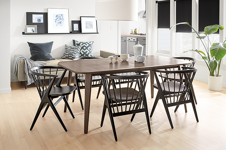 Danish-inspired Soren dining chairs in charcoal stain around modern oval Lowell extension table