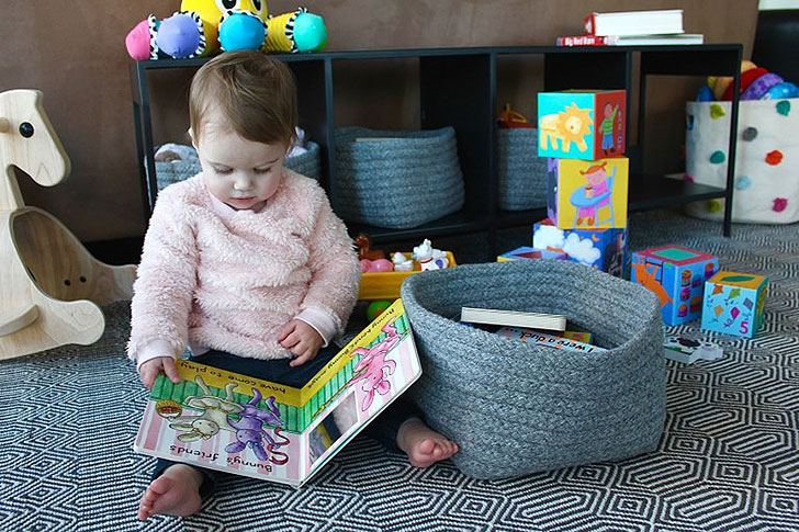 Elle reading a book in her new play area