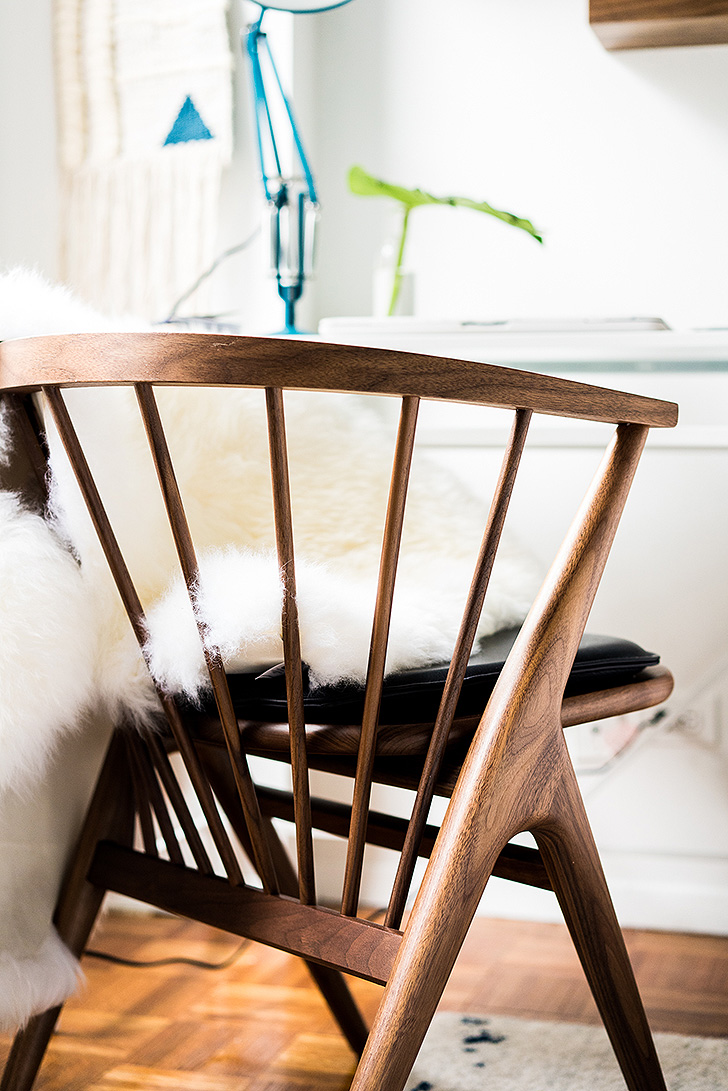Artisan crafted wood chair and sheepskin rug