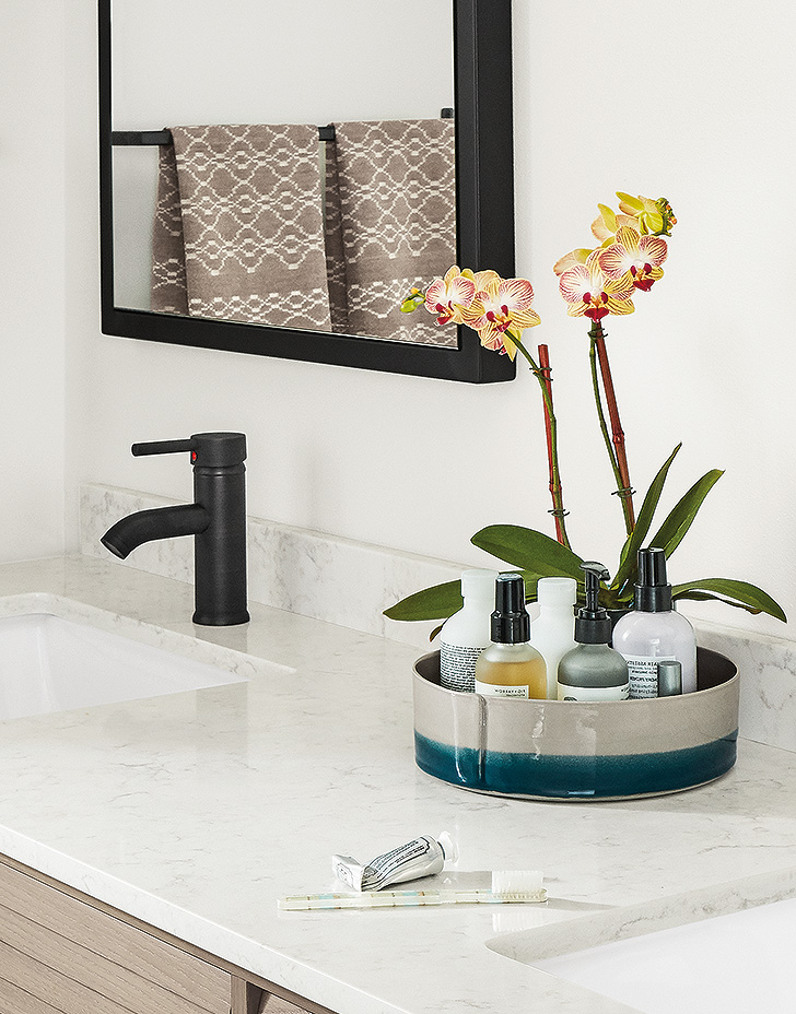 Handmade Cumberland ceramic tray organizes a modern bathroom.