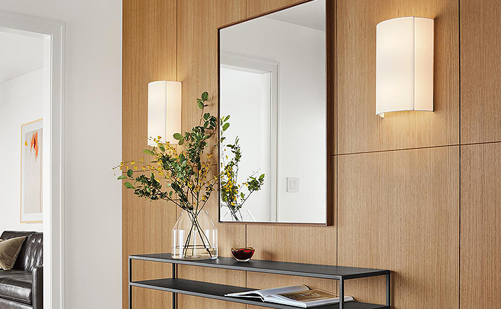 Meara modern wall sconces add gentle lighting to an entryway.