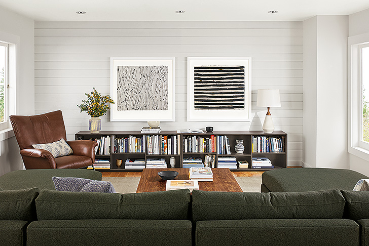 Antje Hassinger artwork displayed in a modern living room above low bookcases
