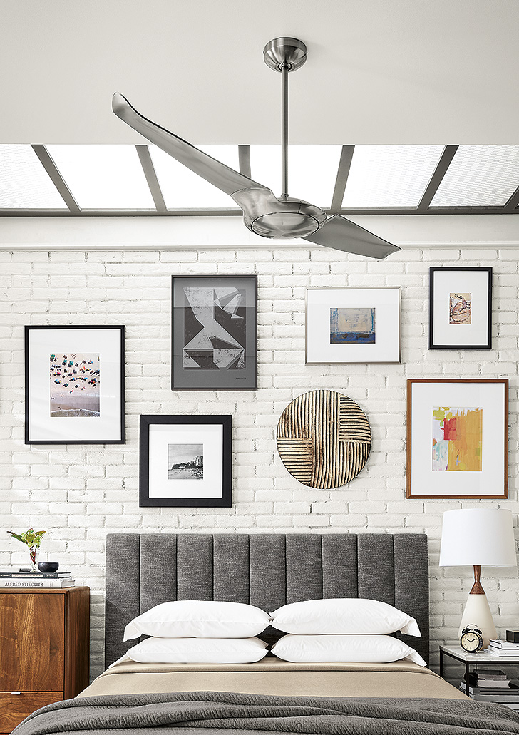 Modern and unique Room & Board artwork displayed above upholstered bed