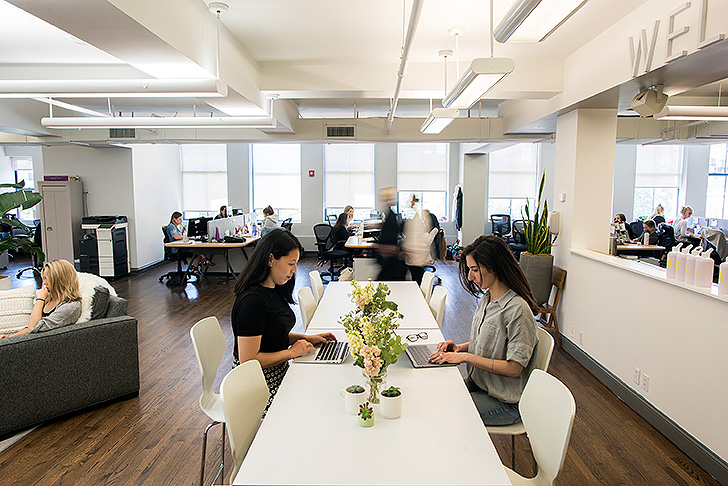 Well+Good employees sitting at long conference table
