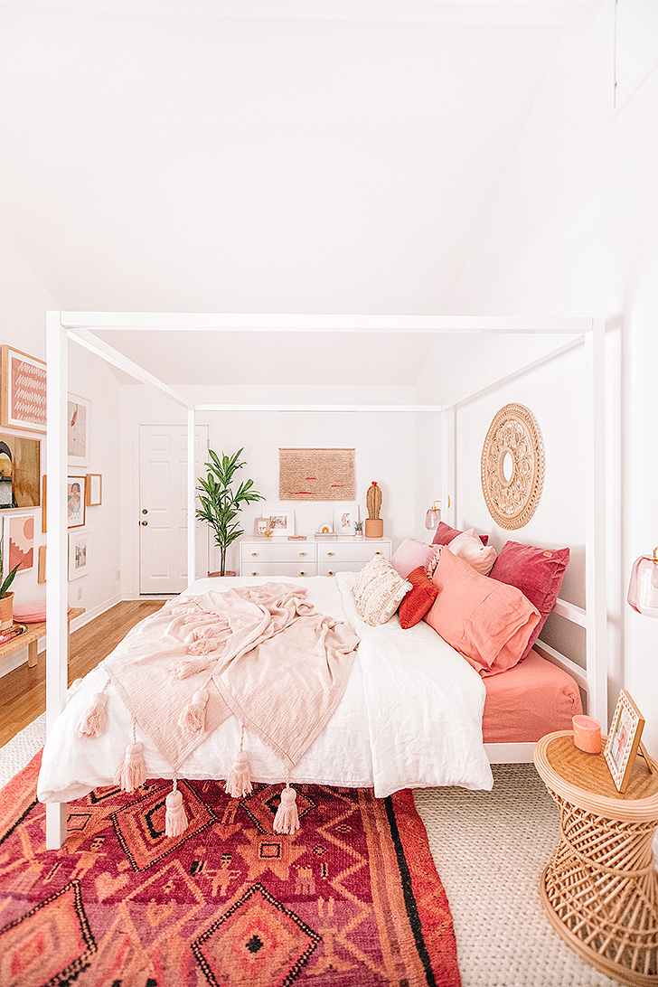 Modern bedroom with canopy bed and pink accents