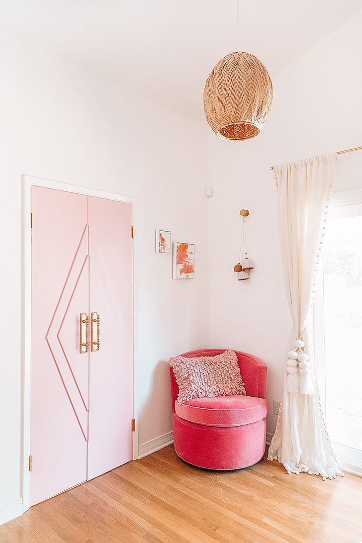 Pink velvet swivel chair in bedroom corner