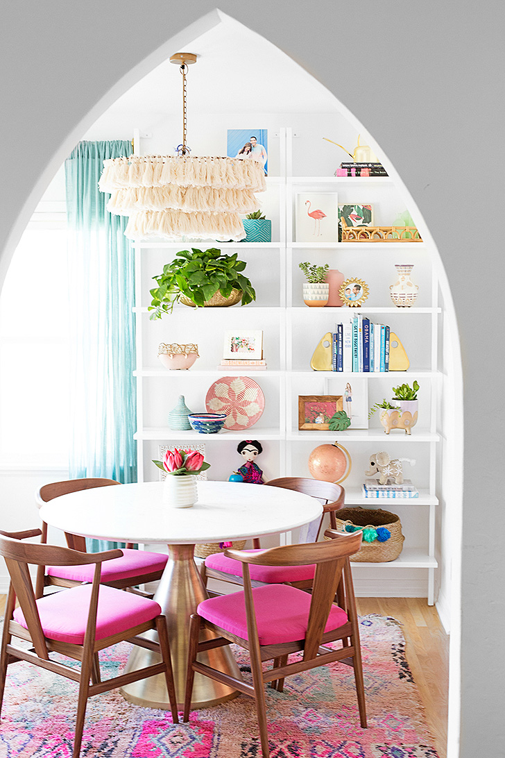 Colorful dining room with bright pink dining chairs