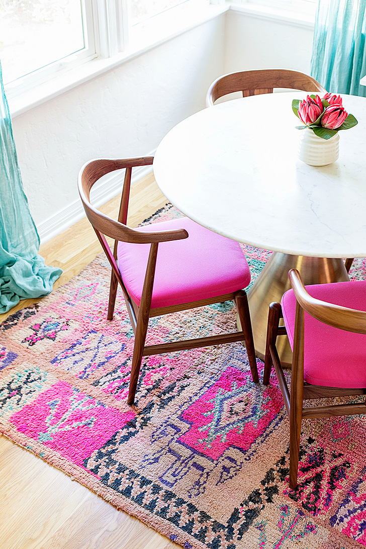 Wood chairs with bright pink seat cushions