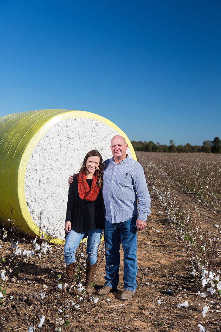 Mark Yeager and Anna Brakefield shown by a cotton bale that will become American-made bedding