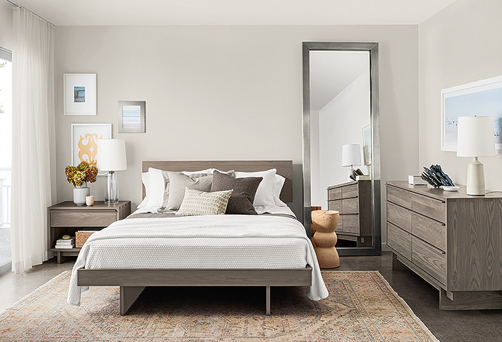 Coastal inspired bedroom with white and grey bedding