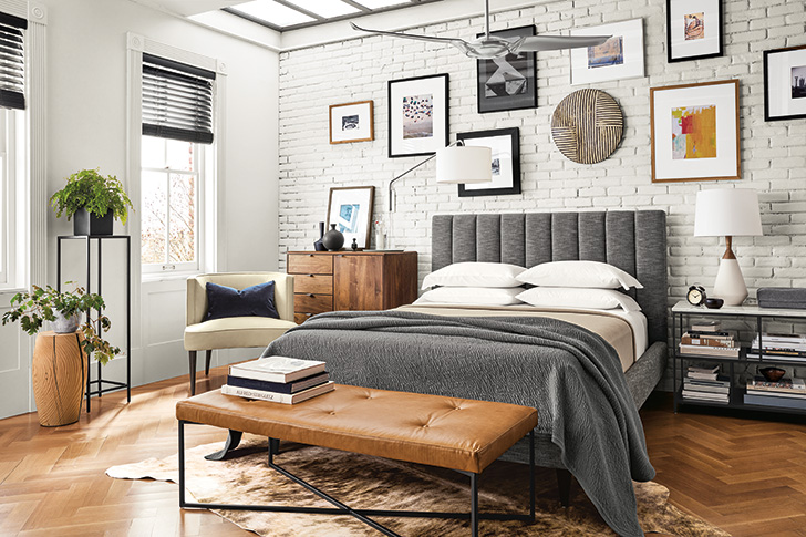 modern grey upholstered bed with neutral bedding