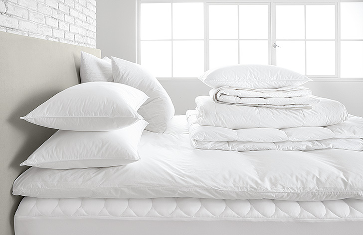 white feather bed, pillows and duvet fillers