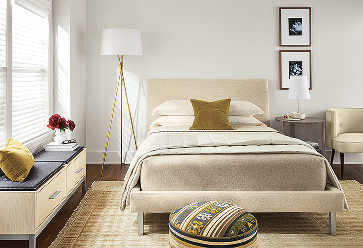 Modern bedroom with upholstered bed, rug, lamps