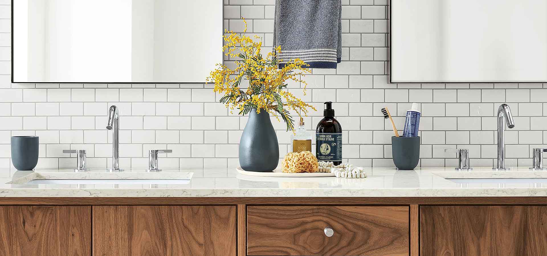 Bathroom vanity stocked with fresh towels and flowers