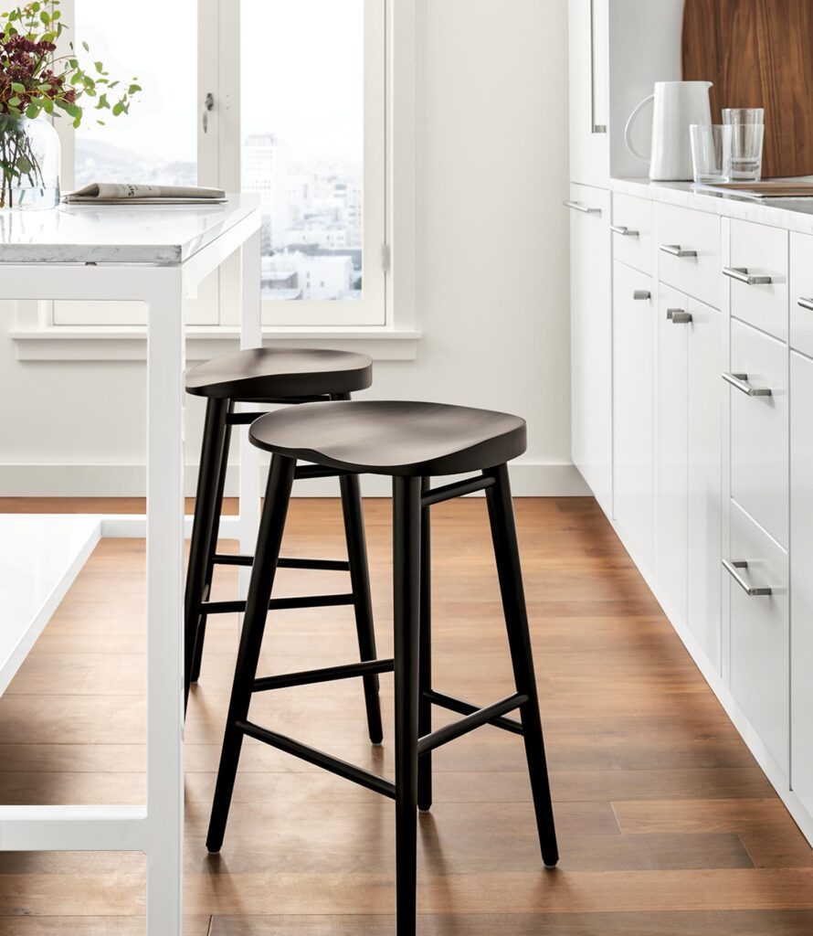 Detail of 2 Bay counter stools in charcoal on cherry at kitchen counter table.