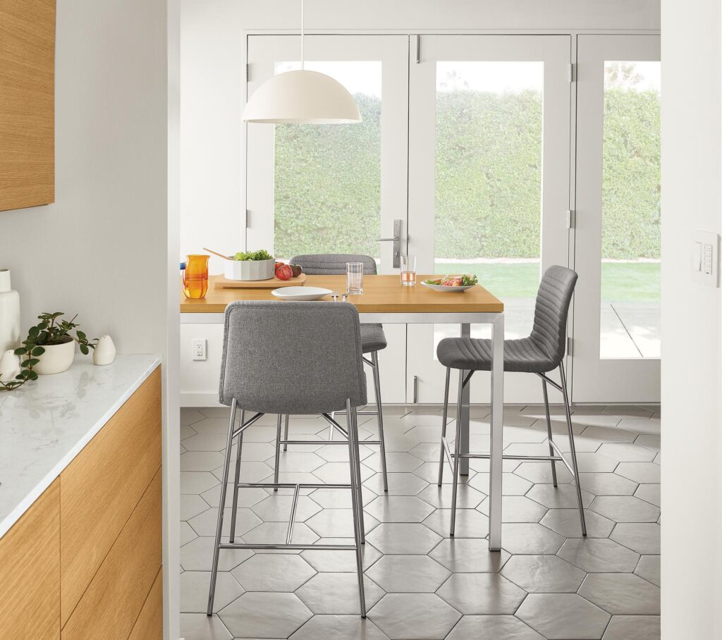 Detail of 3 Cato counter stools in Medley Grey fabric at kitchen counter table.