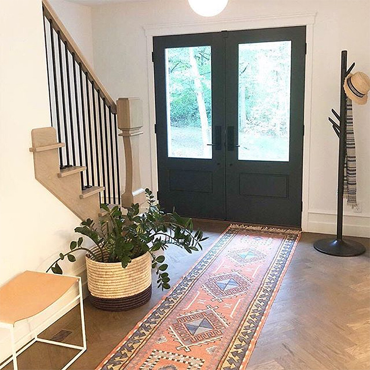 Modern entryway with coat rack and basket storage