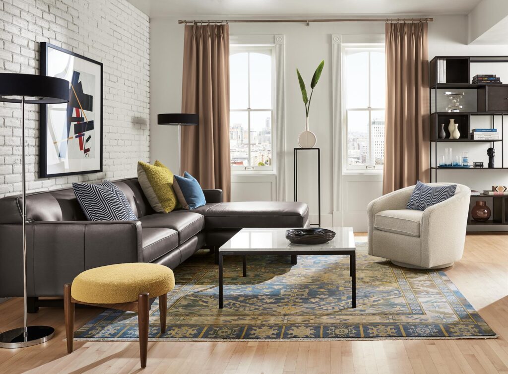 living room with andre leather sofa, amos swivel chair, foshay bookcase with inserts, kayseri rug.