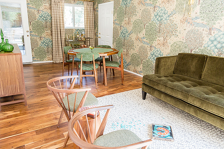 Game room with green velvet sofa and green patterned wallpaper