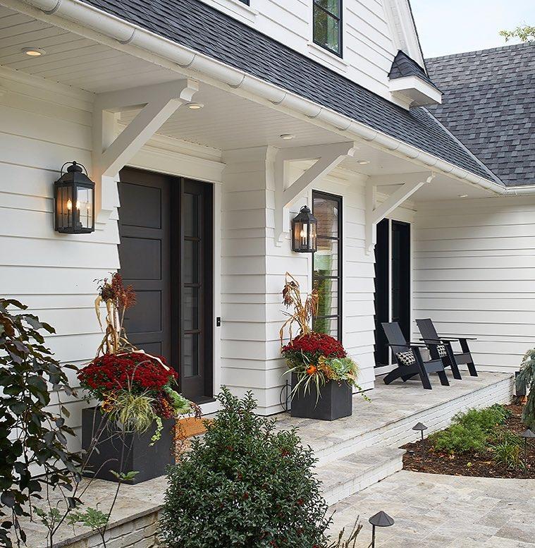 Two outdoor chairs on front porch