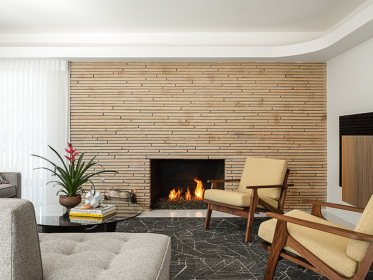 Fireplace with lounge chairs inside the Modernism Week Showcase Home: The Gillman Residence