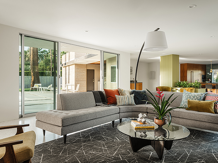 Living room with curved sectional inside the Modernism Week Featured Home: The Gillman Residence