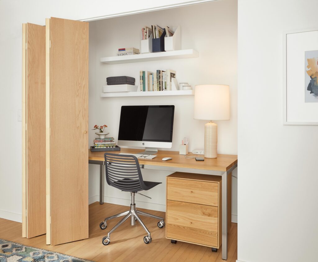 Office setting with 72-inch-wide parsons desk with maple top and white float wall shelves.