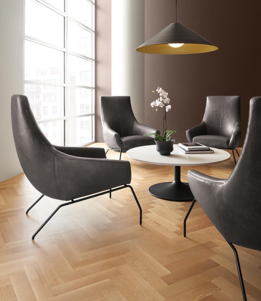 Rhodes leather chairs in Vento smoke with aria coffee table in graphite base with White top.