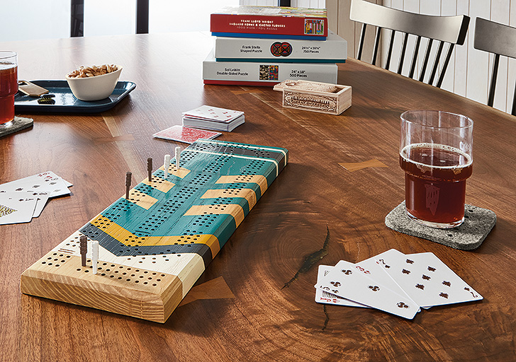 cribbage board next to beer on table