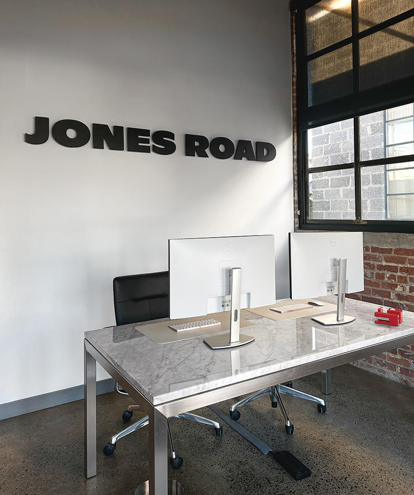 Image of a reception areas at Jones Road Beauty with a Parsons desk and Choral chair.