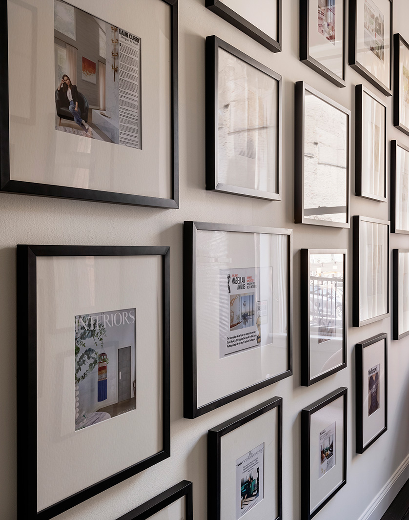 Profile frames hanging in a hallway.
