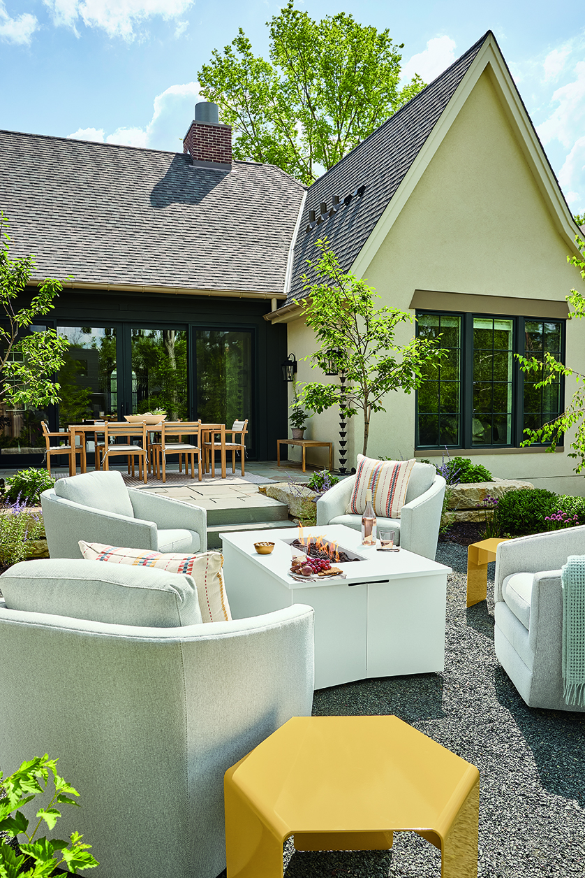 White Adara fire table surrounded by swivel chairs.