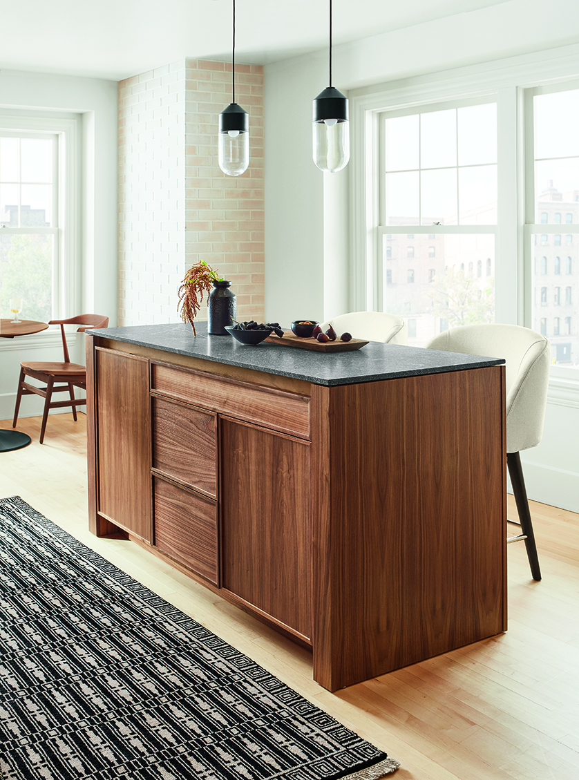 Amherst 60-wide Kitchen Island in walnut with Cora Swivel Counter Stool in Sumner Ivory and Ballad Pendants.
