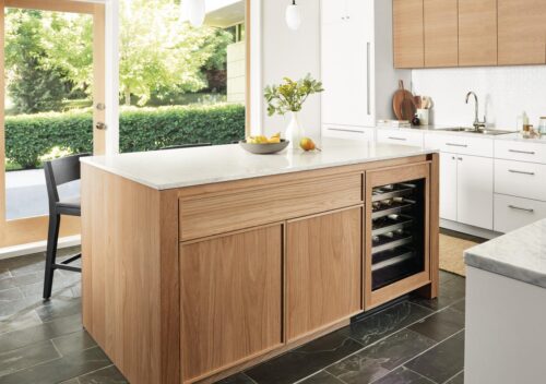 Kitchen with Amherst 72 wide kitchen island with glass door fridge, polar pendant lights and Selby rug in taupe.