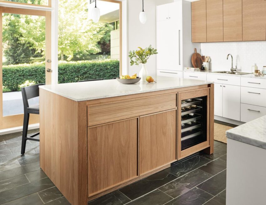 Kitchen with Amherst 72 wide kitchen island with glass door fridge, polar pendant lights and Selby rug in taupe.