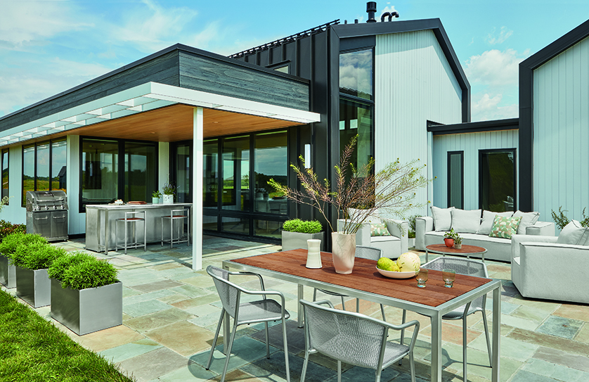 Dining table with a wood top and metal frame surrounded by metal chairs.