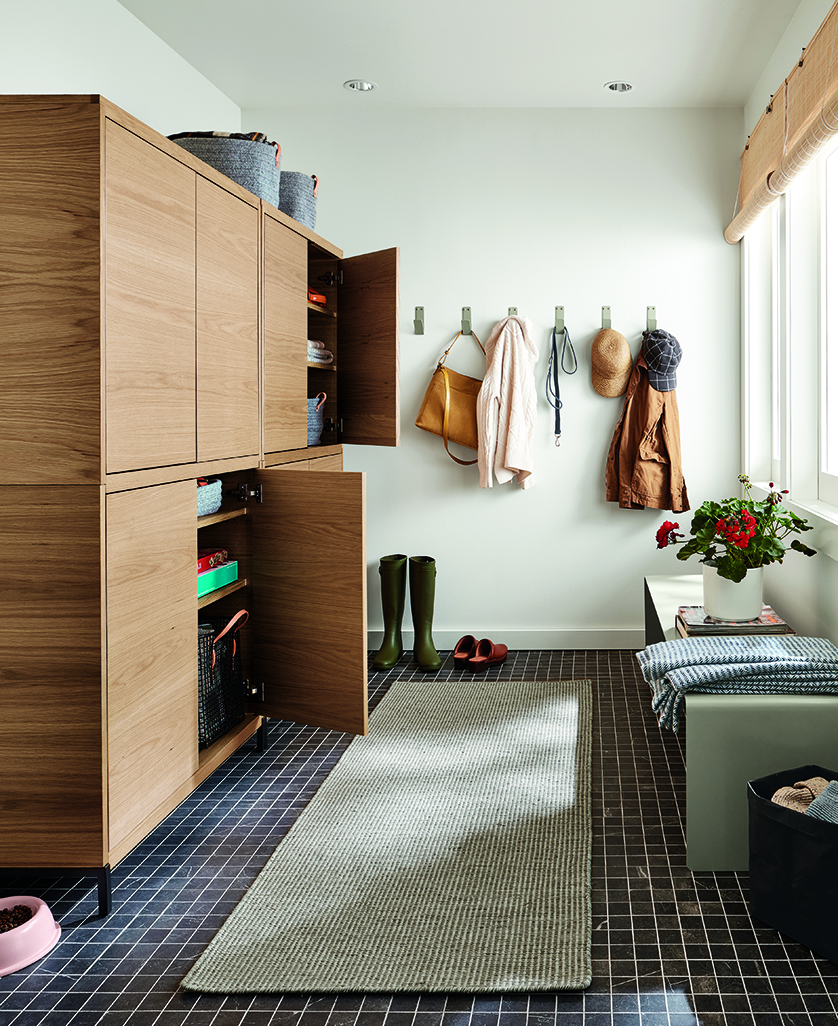 Entryway with Taylor cabinets in rye on red oak with 2 doors open.
