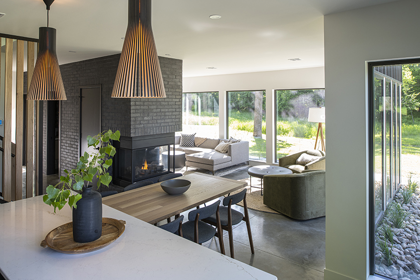 A view looking from the kitchen counter to the living room in a modern Minnesota lake house.