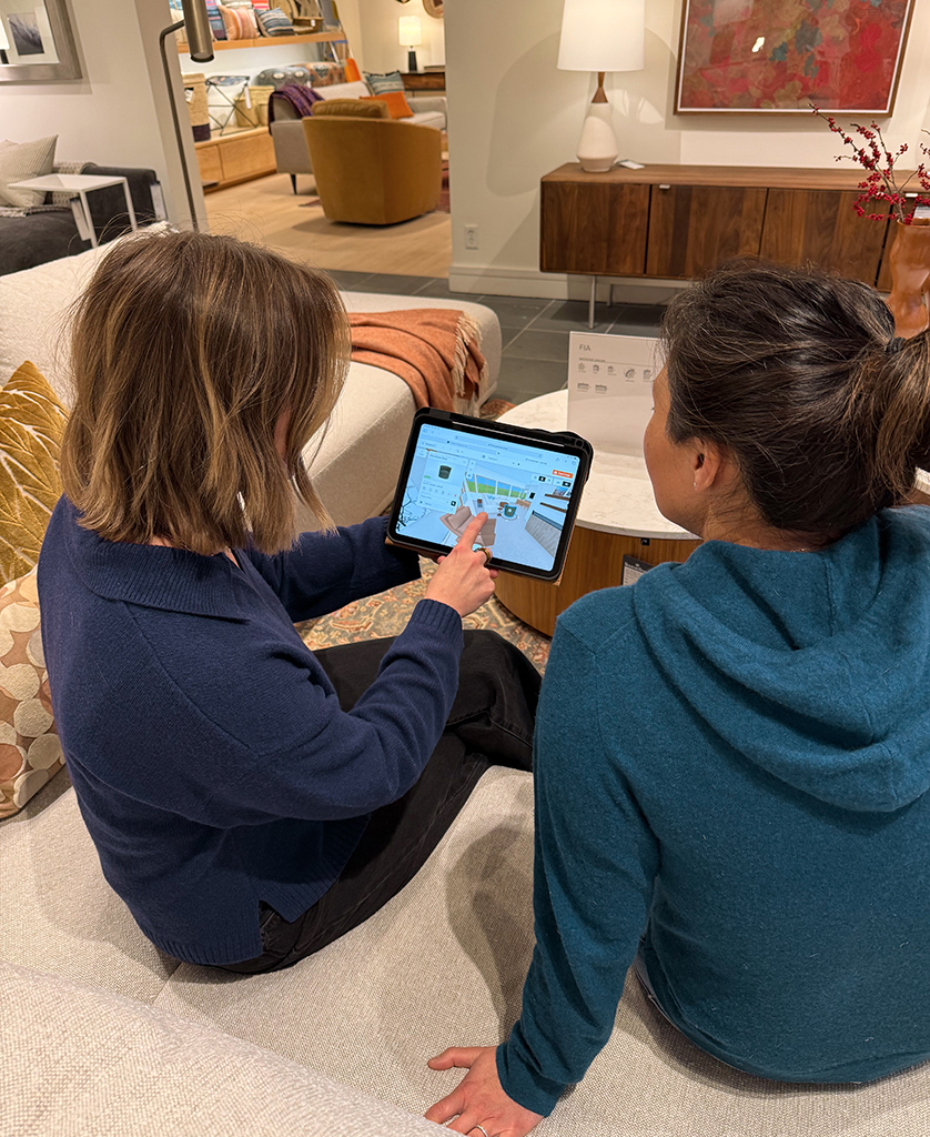 Ann Kim meeting with design associate at Room & Board showroom. 